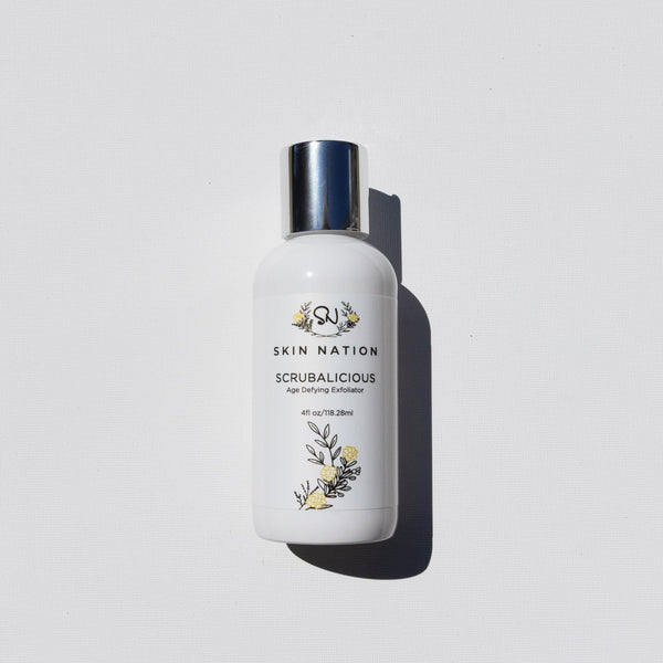 Skincare bottle of Scrubalicious labeled 'Skin Nation' on a light gray background